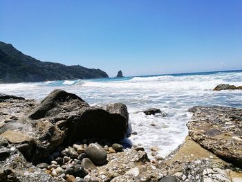 Scenic view of sea against clear blue sky