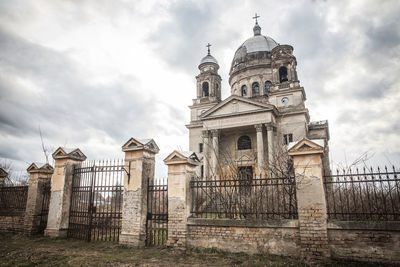 Low angle view of abandoned church against sky