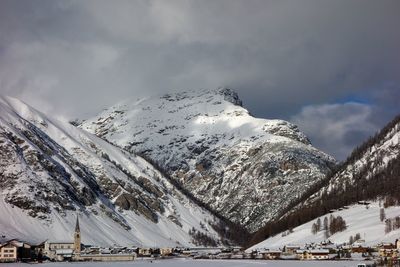 Scenic view of snow covered mountains against sky