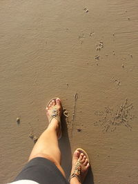 Low section of woman walking at beach