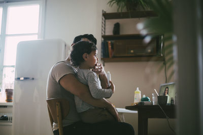 Woman sitting on chair at home