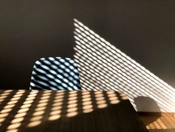 Close-up of sunlight falling on table against wall