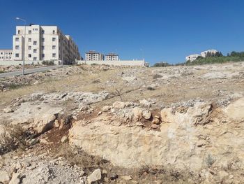 Scenic view of rock formations against clear blue sky
