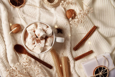 Cup of hot chocolate with a marshmallow and christmas decorations. winter cozy home concept