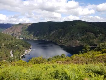 Scenic view of lake and mountains against sky