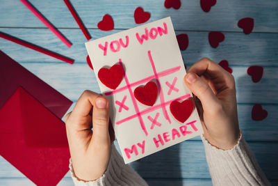 Cropped hands of woman holding gift