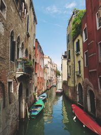 Boats in canal with buildings in background