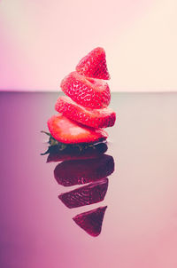 Close-up of strawberry on table against gray background