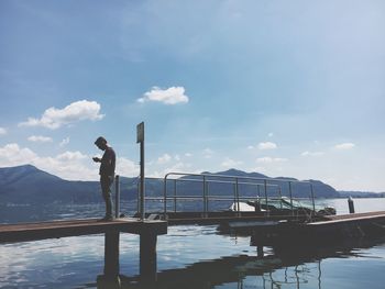 Man standing by sea against sky