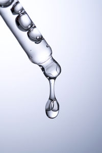 Close-up of spoon against blue background