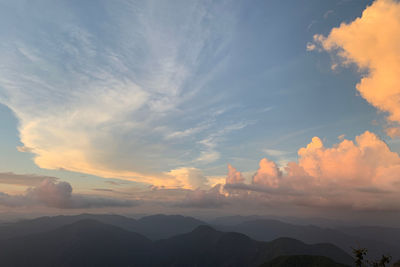 Scenic view of silhouette mountains against sky at sunset