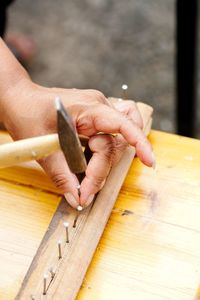 Close-up of hands working on table