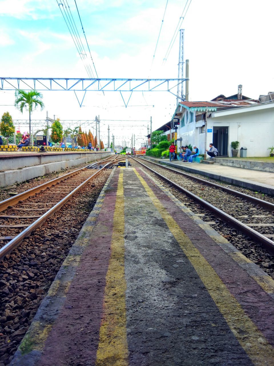 TRAIN ON RAILROAD TRACK AGAINST SKY