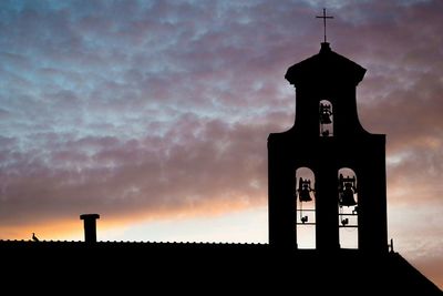 Low angle view of built structure against cloudy sky