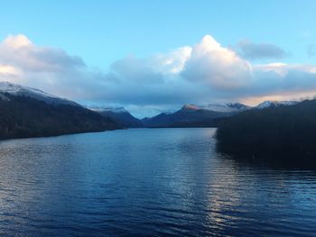 Scenic view of lake against cloudy sky