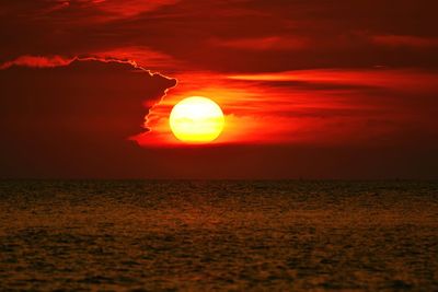 Scenic view of sea against romantic sky at sunset