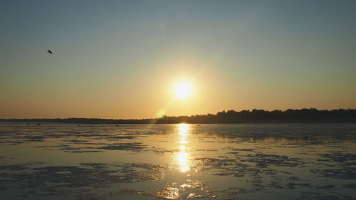 Scenic view of sea against clear sky during sunset