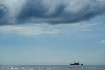 Scenic view of sea against sky with ship sailing