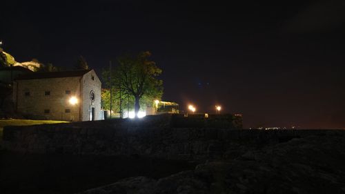 Illuminated building against sky at night