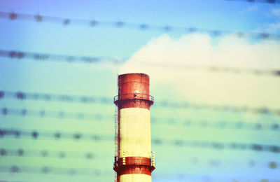 Close-up of glass bottle against sky