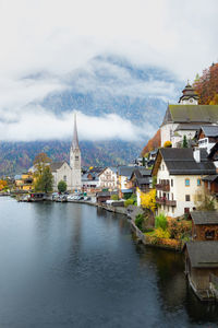 River amidst buildings in city against sky