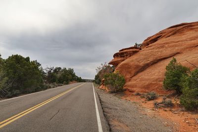 Landscape of road, plants and rounded orange rock formation