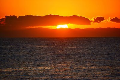 Scenic view of sea against romantic sky at sunset