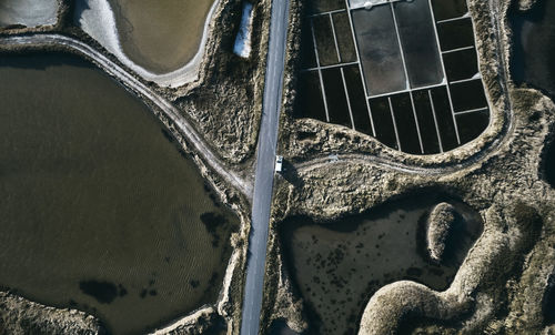 Road amidst salt flat on sunny day