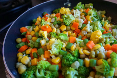 Vegetable salad with colorful broccoli, beans, peas, carrot and corn kernels. selective focus