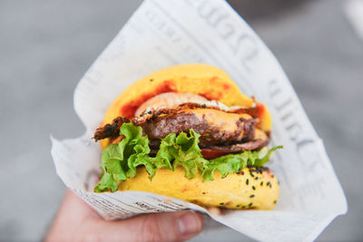 Close-up of hand holding burger