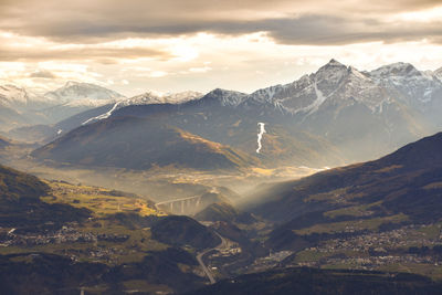 Scenic view of mountains against dramatic sky during sunset