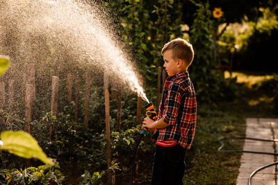 Full length of boy standing in water