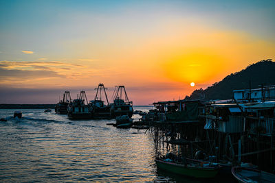 Sailboats in marina at sunset