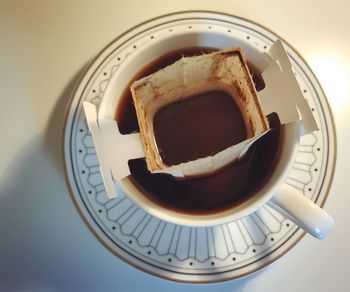 High angle view of coffee in cup on table