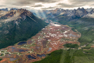 High angle view of land and mountains against sky