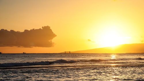 Scenic view of sea against orange sky