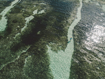 Woman wading in sea