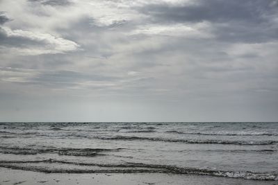 Scenic view of sea against cloudy sky