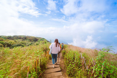 Group asian woman traveler hiking and embracing nature from top of mountain in spring season