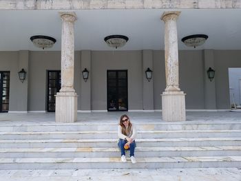 Portrait of woman against steps