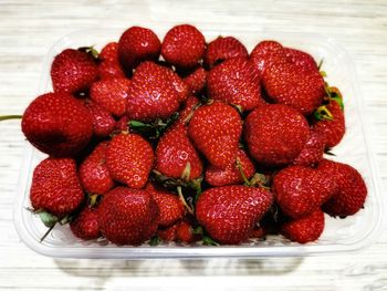 High angle view of strawberries in bowl on table
