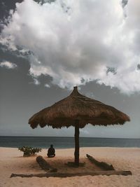 Lifeguard hut on beach against sky