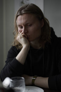 Sad woman sitting at table