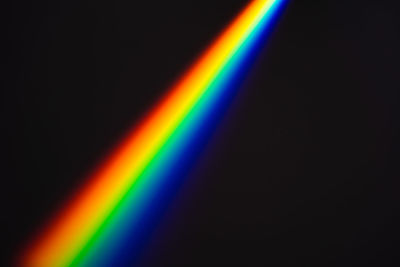 Scenic view of rainbow against black background