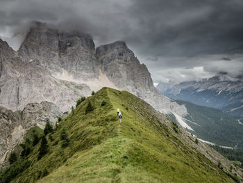 Mid distance image of people hiking on dolomites