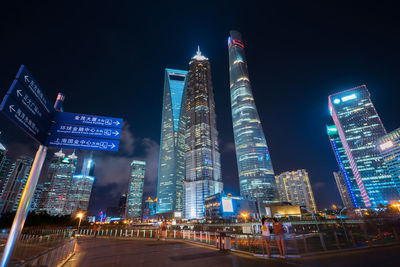 Low angle view of illuminated city lit up at night