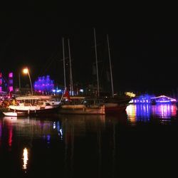 Boats in harbor at night