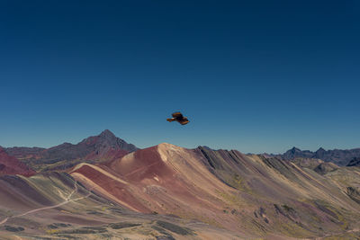 Scenic view of mountains against clear blue sky