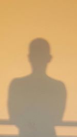 Shadow of man on white wall
