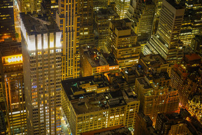 High angle view of illuminated buildings in city at night